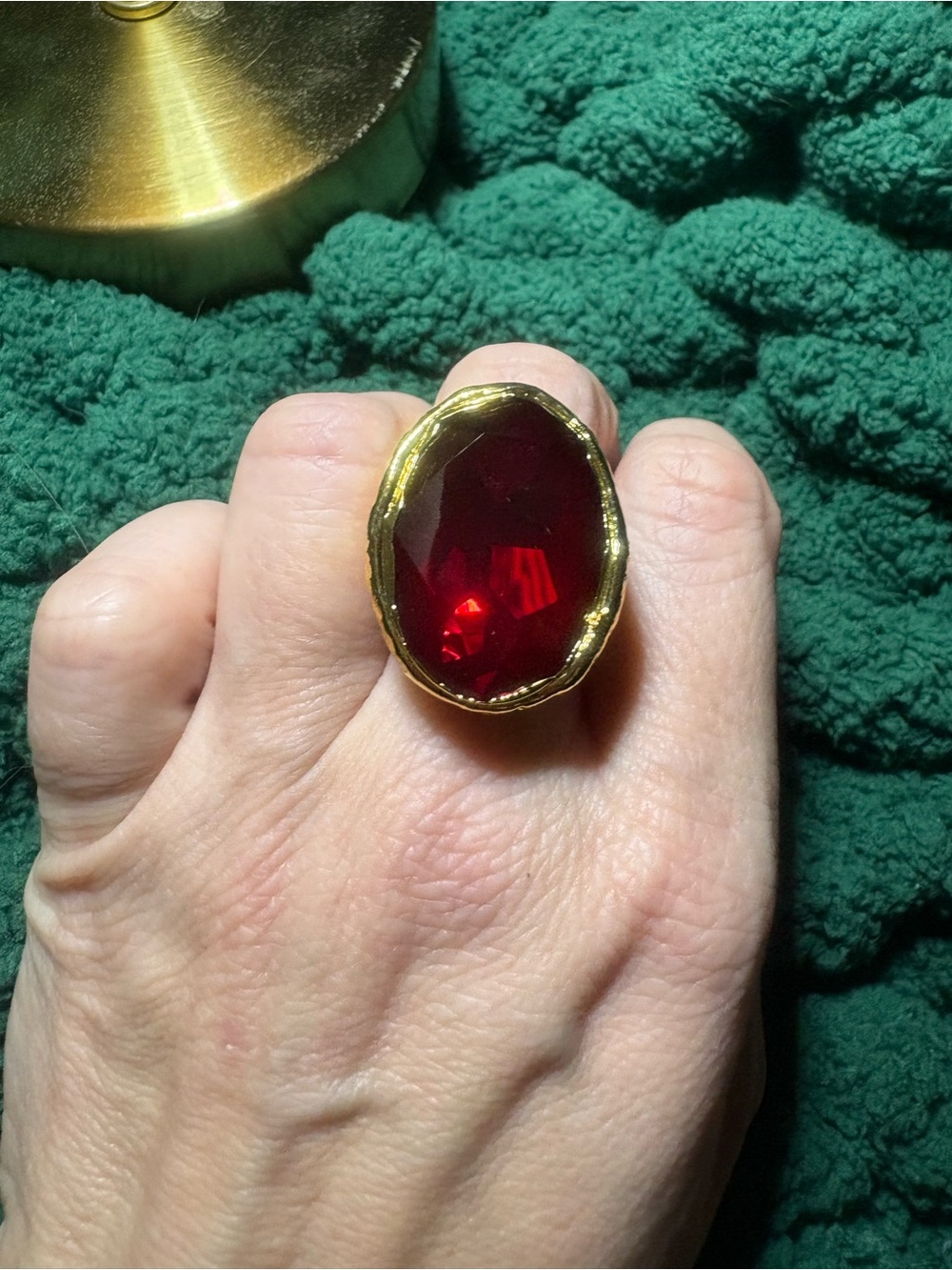 Gold-Tone Ring with Deep Red Oval Gemstone